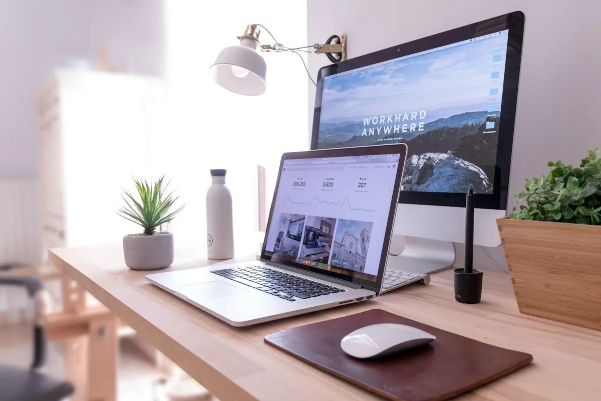 Clean professional desk with a laptop and monitor